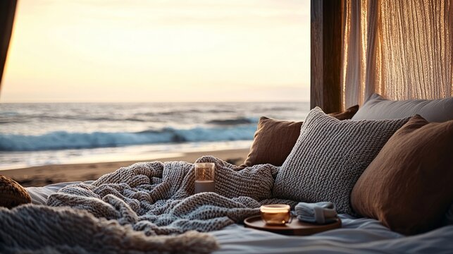 Cozy beachside setting with a bed, pillows, and a sunset view, perfect for relaxation and tranquility.