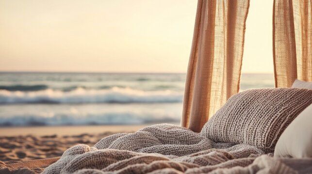 Cozy beach setup with soft bedding and gentle ocean waves in the background, perfect for relaxation.