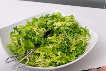 A fresh lettuce salad in a bowl, elegantly displayed on a hotel buffet. Perfect for showcasing healthy dining options and vibrant food presentation.