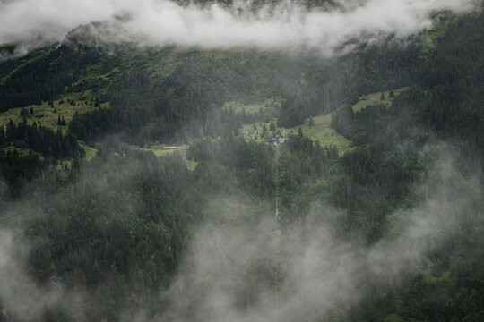 View of the majestic Lauterbrunnen valley surrounded by lush mountains and clouds, Lauterbrunnen, Switzerland.