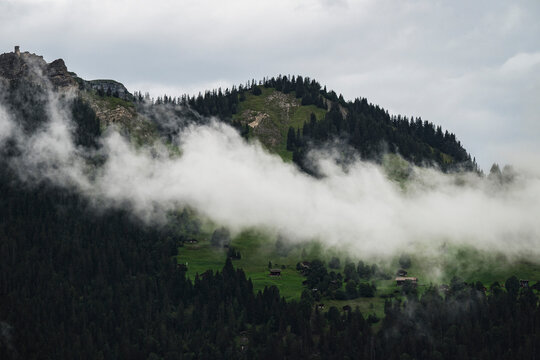View of majestic Bernese Alps with fog and greenery, Lauterbrunnen, Switzerland. - Powered by Adobe
