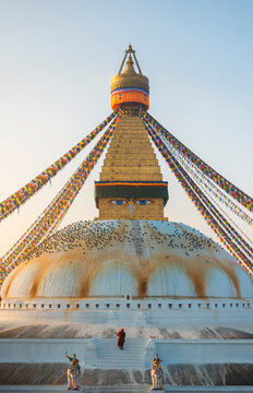Kathmandu, Nepal - 30 December 2023: View of Boudhanath temple with colorful prayer flags and people, Kathmandu, Nepal.