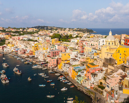 View of colorful buildings and fishing boats at Marina Corricella, Isola di Procida, Italy.