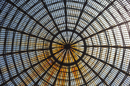 View of elegant glass ceiling and ornate dome in historic Galleria Umberto I, Naples, Italy.
