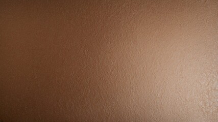 A minimalistic close-up of a smooth brown textured surface, emphasizing simplicity and natural earth tones.