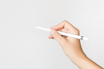hand writes with pad stylus on grey background
