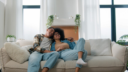 African American spouses couple man woman girl guy on sofa couch at home own apartment together...