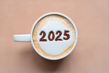 Top view of a mug with coffee and cocoa powder in the shape of 2025