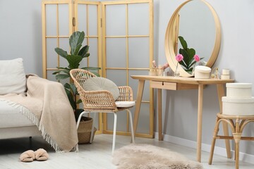 Mirror, dressing table, houseplant, folding screen and chair indoors. Interior design