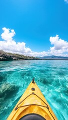 A kayak glides over crystal-clear turquoise water under a bright blue sky with fluffy white clouds.