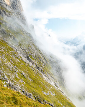 View of a Mountain Vally in The Dolomites filled with clouds, Province of Trento, South Tirol, Italy
