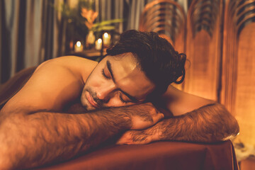 Caucasian man customer enjoying relaxing anti-stress spa massage and pampering with beauty skin...