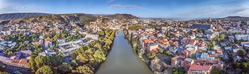 Drone panorama of Tbilisi, Georgia, with the Kura River at sunrise showcasing the cityscape © Aquarius