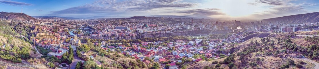 Drone panorama of Tbilisi, Georgia, with the Kura River at sunrise showcasing the cityscape © Aquarius
