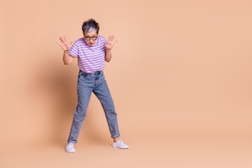 Photo of worried nervous adorable woman wear purple trendy clothes look down empty space isolated on beige color background