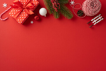 Brightly colored Christmas decorations and gifts on a classic red background evoke festive cheer...