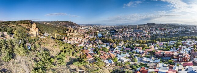 Drone panorama of Tbilisi, Georgia, with the Kura River at sunrise showcasing the cityscape © Aquarius