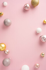 A vertical collection of elegant Christmas ornaments arranged on a soft pink background. The festive decor features various colors like gold, white, and pink, creating a sophisticated holiday vibe