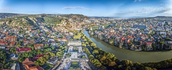 Drone panorama of Tbilisi, Georgia, with the Kura River at sunrise showcasing the cityscape © Aquarius
