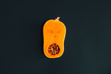 Butternut squash carved with spooky face, showcasing creative Halloween decoration ideas