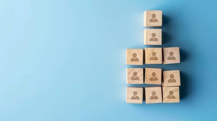 Hierarchy and leadership concept. A bunch of wooden blocks with people icons isolated on blue background
