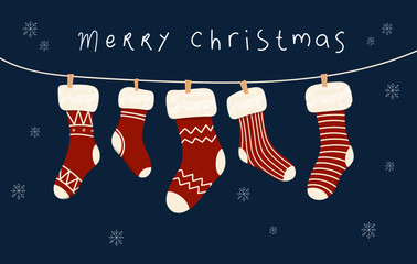 Hanging Christmas socks or stockings on rope with various cute patterns with words Merry Christmas. Christmas Holiday Socks.