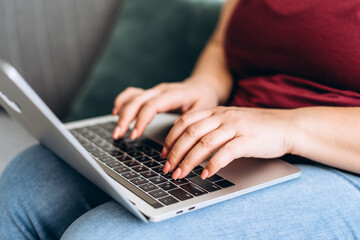 Close up of female hands typing on laptop