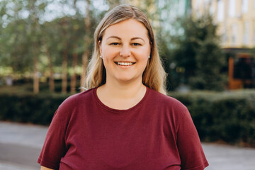 Portrait of plus size woman in casual posing at camera on the street