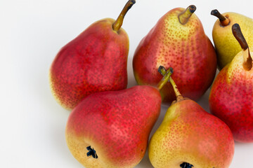 Pears and fruit in gray on a. Food healthy fresh concept. Ripe pears lying on a gray. A ripe pear lying on a green with red and white fruits lifestyle.