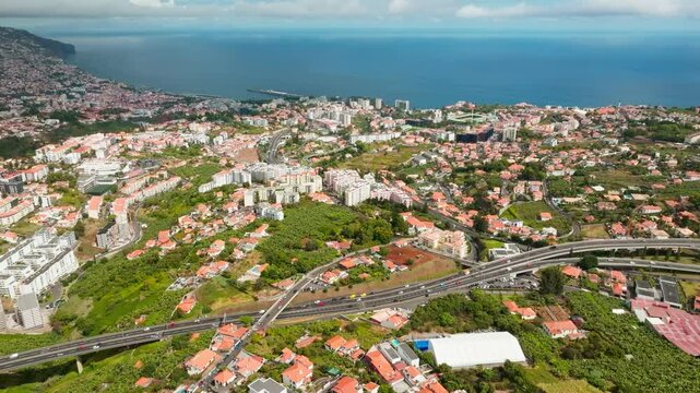 Aerial drone view of Funchal town, Madeira island, Portugal. Push in approach dolly move