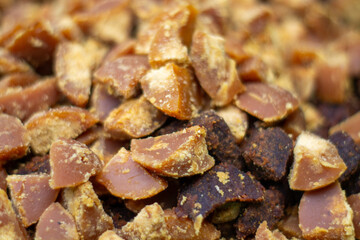 A pile of fresh brown sugar or palm sugar that has been cut into small pieces.