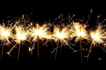 Fototapeta premium Sparkling celebration with bright sparklers on dark background