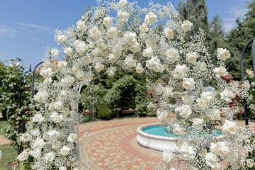 a beautiful arch for a wedding ceremony in a park with chairs