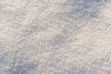 Natural snow texture. Smooth surface of clean fresh snow. Snowy ground.