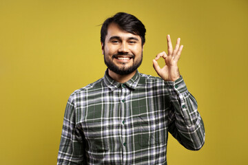 smiling man making OK sign with his hand