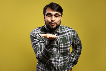 man blowing something that is in his hand