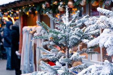 Snow covered, Christmas tree at a Christmas market in a city in Europe. Close up shot, selective focus,