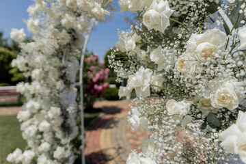 a beautiful arch for a wedding ceremony in a park with chairs