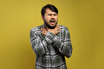 man with his hands on his throat, feeling a lot of sore throat