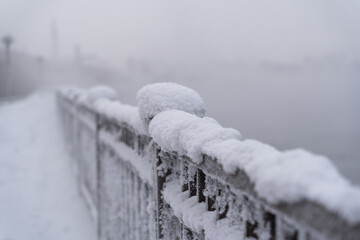 Embankment and the park are covered with snow in a severe frost