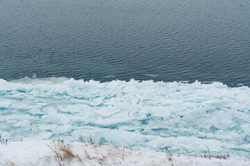 Transparent and clean ice of Lake Baikal. Lake in winter.