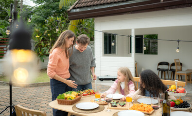 Grandfather, parents, and the teenage girls are all having dinner together at home