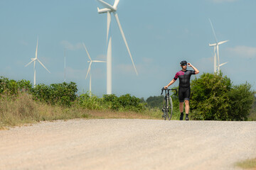 Obraz premium Cyclists are riding their bikes for training and touring the wind farms