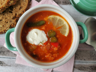 Traditional East German Soljanka Soup with Pickles, Leftover Sausage  and Sour Cream