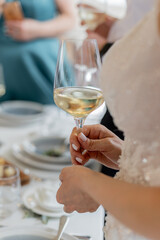 a man holds a glass of champagne in his hand at a celebration in a restaurant