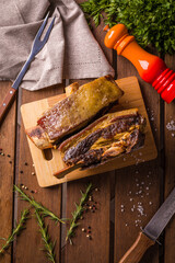 Delicious Grilled Ribs on Wooden Board With Fresh Herbs and Spices