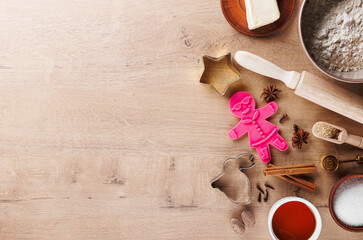 Ingredients for baking cookies: flour, rolling pin, spices, sugar, honey, butter, ginger, gingerbread mold. Cooking holiday cookies with copy space