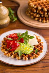 Delicious Waffles Topped With Fresh Avocado and Tomatoes