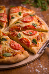 Fresh Italian Margherita Pizza Sliced With Tomatoes And Basil