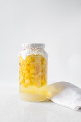 pineapple cheong in a glass jar on a white background, korean pineapple cheong in a transparent...